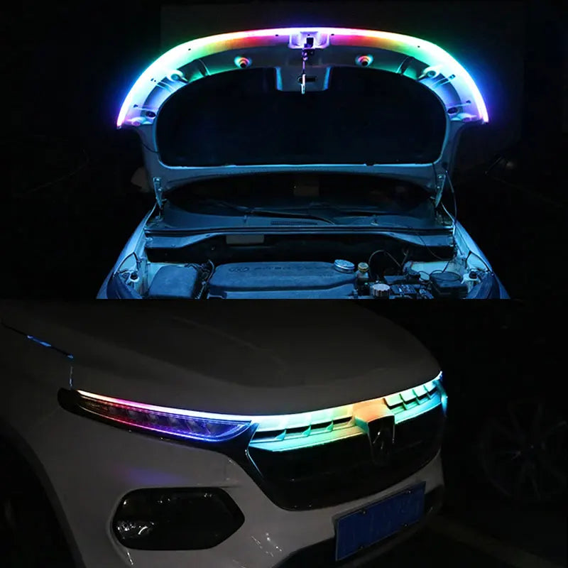 Close-up of an RGB LED light strip installed on a car hood, showing colorful illumination.