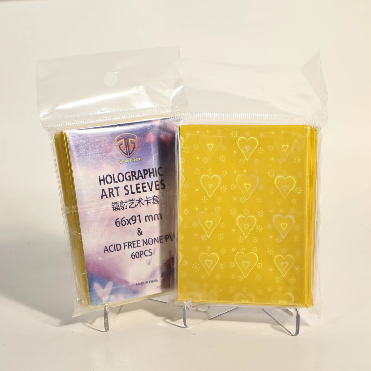A clear plastic package containing 60 holographic heart-shaped art sleeves for trading cards.