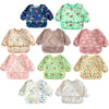 A collection of colorful waterproof long-sleeve baby bibs featuring various patterns and designs.