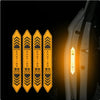 A pack of four yellow and black chevron reflective warning stickers displayed against a dark background.