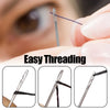 Close-up of a stainless steel self-threading sewing needle being used for hand sewing.