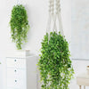 Artificial green hanging vine with long white strands used as indoor and outdoor decor