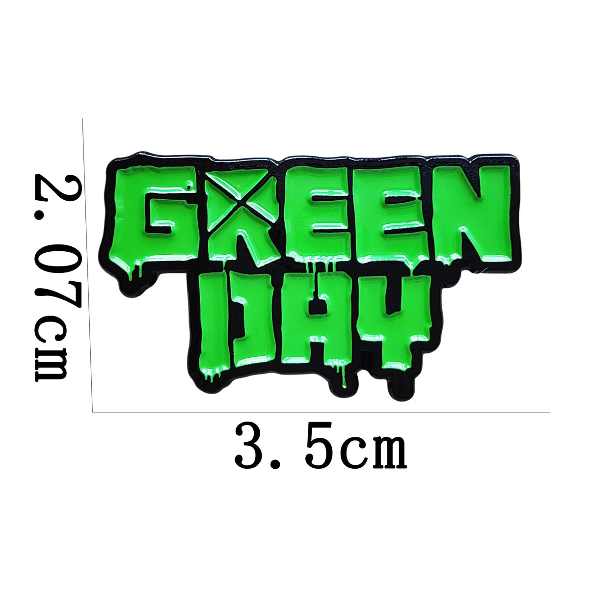 A bright green enamel pin featuring the text GREEN DAY with a cross symbol.
