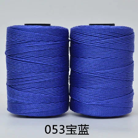 Two spools of blue 3-ply polyester knitting yarn for crochet and hand crafts
