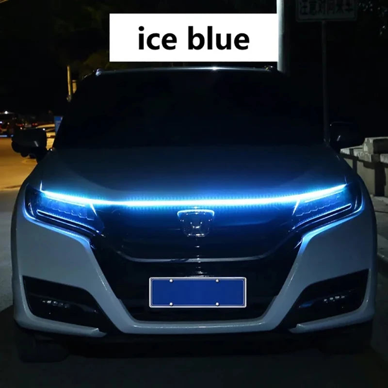 A close-up of a car's front grille with an ice blue LED light strip displaying a scan effect.