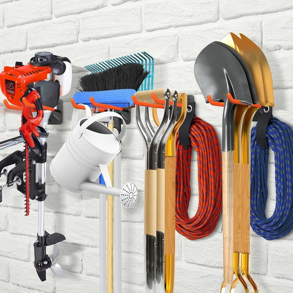 A wall-mounted organizer rack displaying various heavy-duty garden tools including shovels, hoes, and other implements.