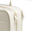 A close-up of a cream-colored portable hanging toiletry bag with a zipper detail.