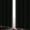A close-up view of a blackout curtain with a white vertical light strip revealing a textured, light-colored surface.
