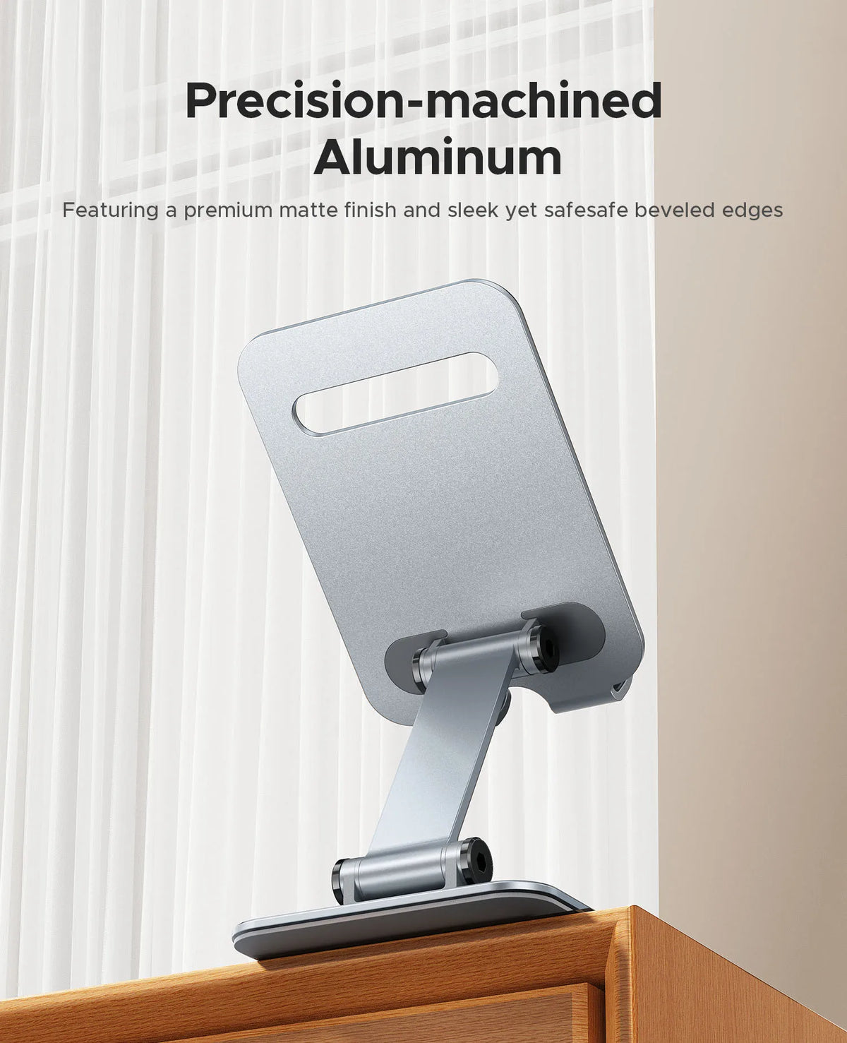 A precision-machined aluminum phone stand with a matte finish and beveled edges, shown against a light background.