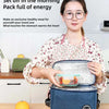 A woman holds a blue thermal insulated lunch bag containing a healthy meal, demonstrating the product.