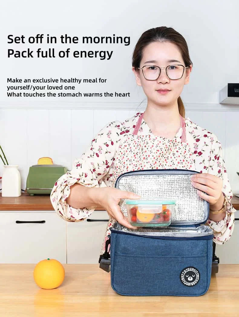 A woman holds a blue thermal insulated lunch bag containing a healthy meal, demonstrating the product.