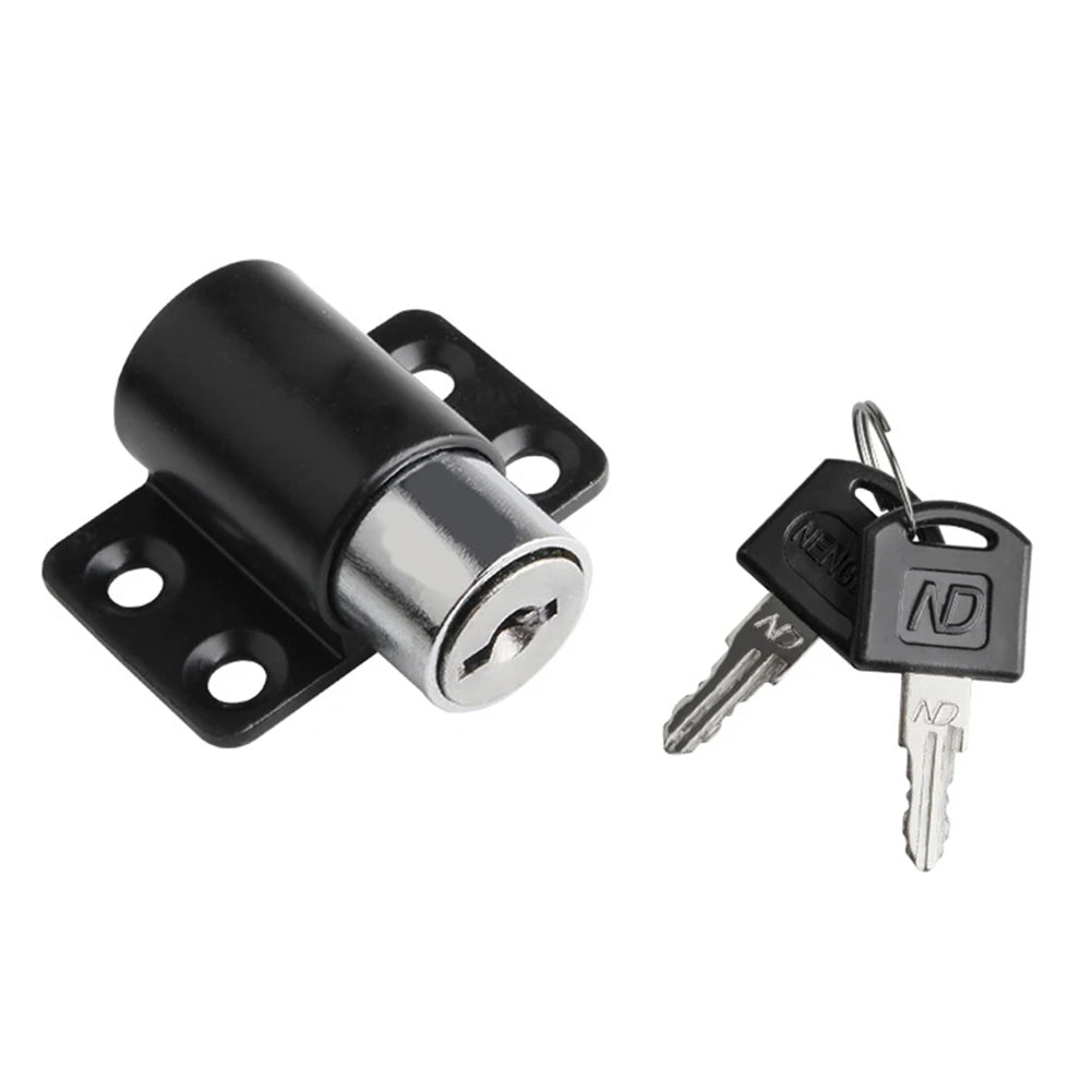 A black sliding door window lock mechanism with a key and a spare key.