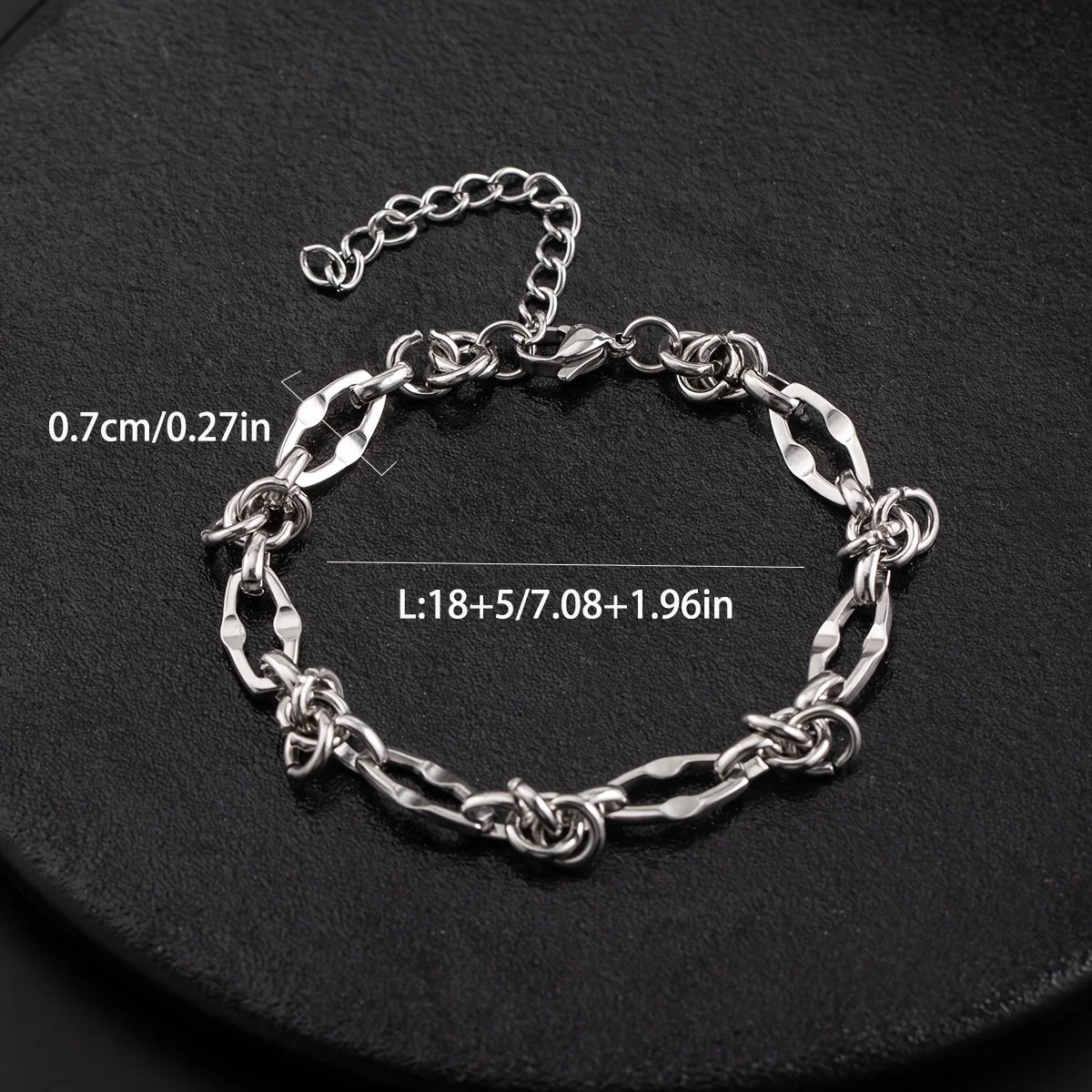 Silver titanium steel chain bracelet with knot detail displayed on a black background