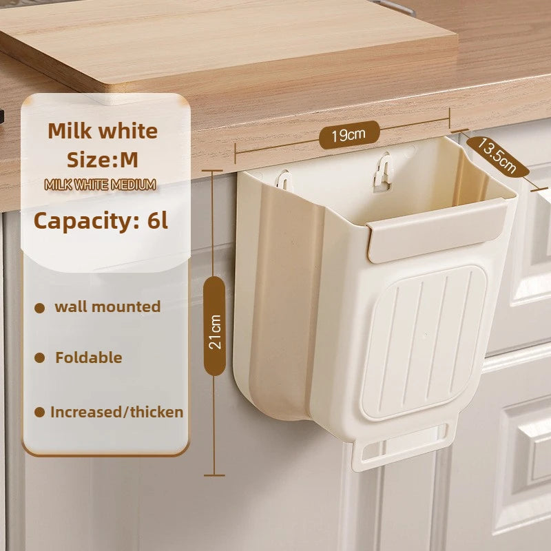 A beige foldable hanging trash bin with a lid is shown mounted on a wooden cabinet shelf.