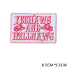 Pink embroidered letter patch with the text YEEHAWS AND HELLNAWS in red thread.