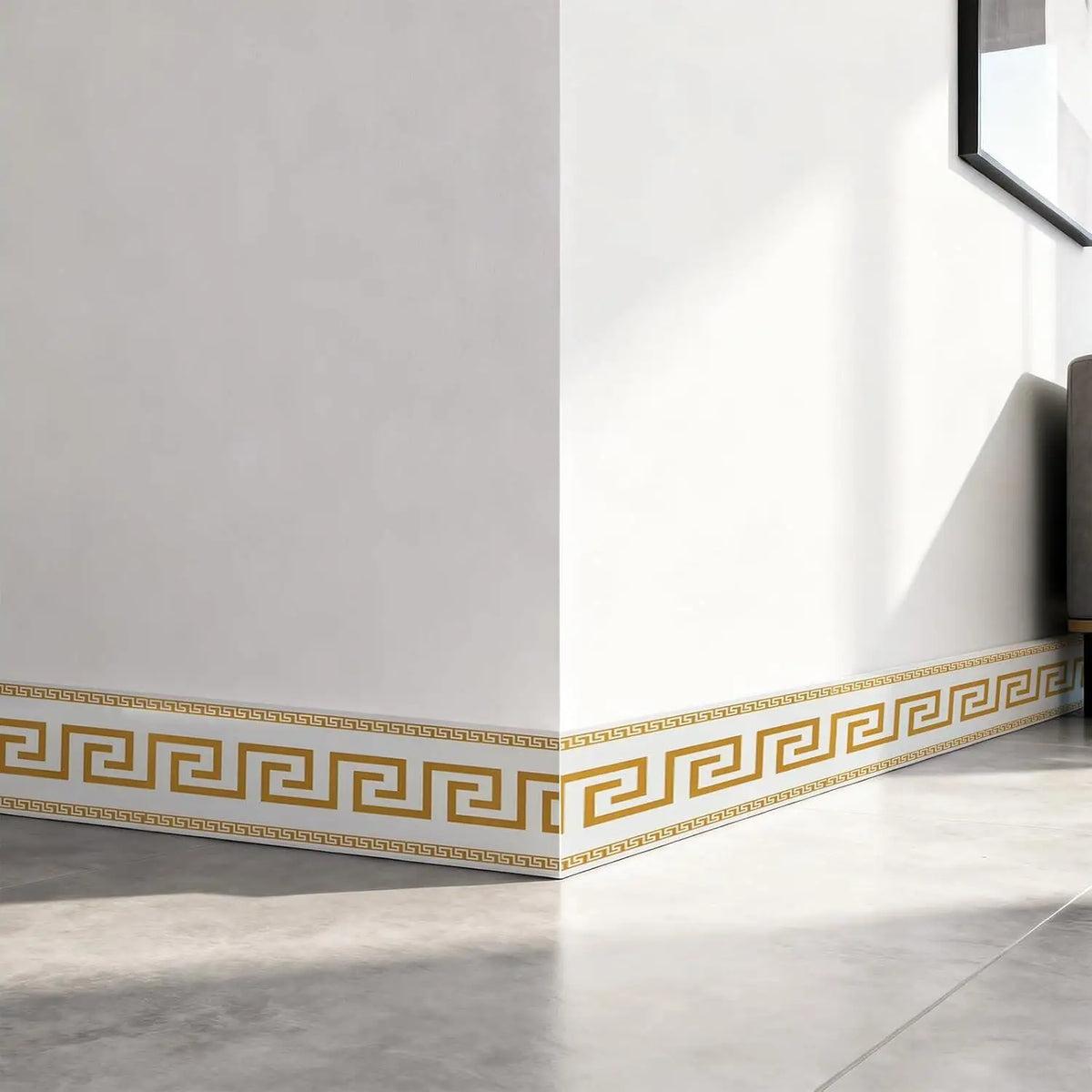 A white wall features a gold geometric border trim along the baseboard.