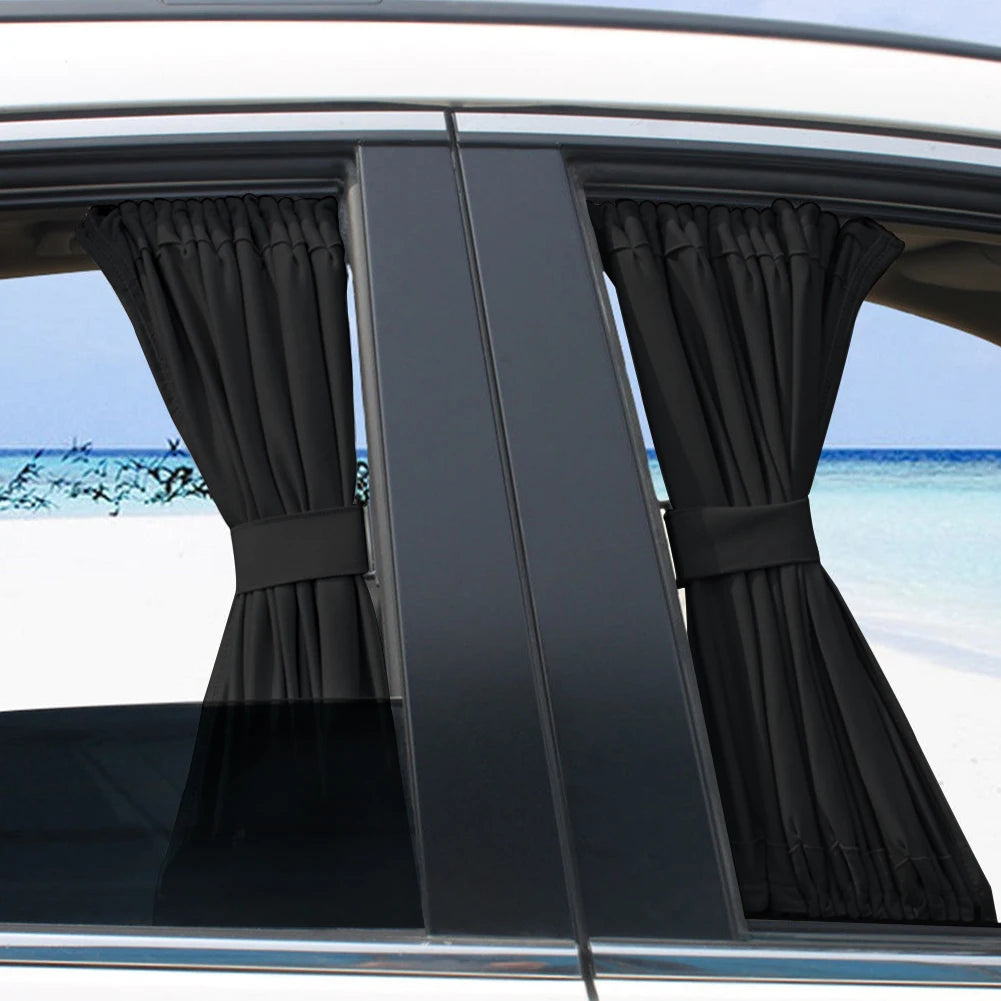 Black fabric sun shade covering a car side window with UV protection against bright sunlight.