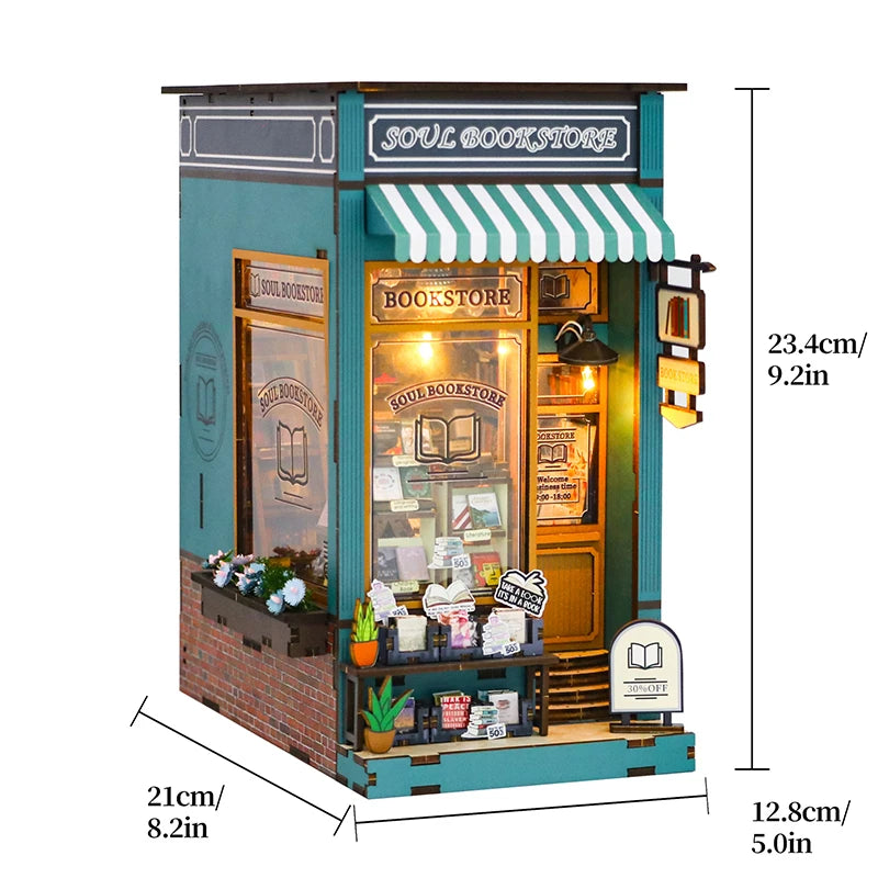 A miniature DIY bookstore room scene featuring a wooden shelf with glass display cases and striped awning.