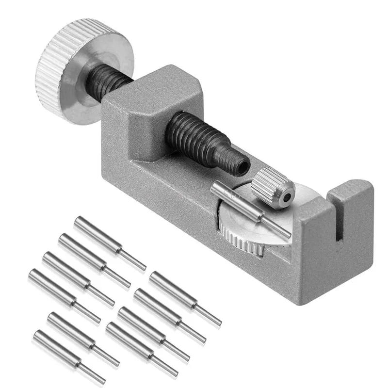 A gray watch band link remover and pin extractor kit with a threaded tool and several metal pins.
