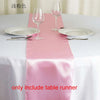 Pink satin table runner set with wine glasses and plates for an elegant event setting