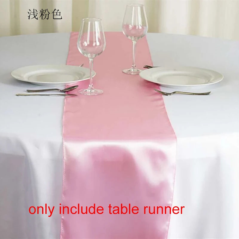 Pink satin table runner set with wine glasses and plates for an elegant event setting