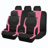 A set of five black and pink two-tone car seat covers arranged in a row.
