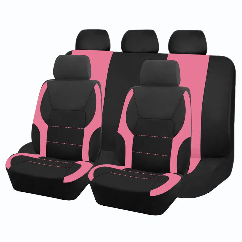 A set of five black and pink two-tone car seat covers arranged in a row.