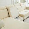 A light beige elegant stretch sofa slipcover with a textured fabric and a removable back cushion.