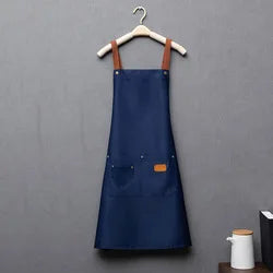 Navy blue waterproof adjustable kitchen apron hanging on a wooden hanger