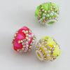 Three spherical beads made of green, pink, and yellow rhinestones and white round beads for jewelry making