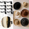 A collection of minimalist black and natural fiber hat hooks displayed on a white background.