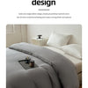 A solid gray washed cotton brushed duvet cover is displayed on a bed with white pillows and a wooden nightstand.