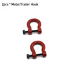Two red metal trailer hooks for RC crawler decoration.