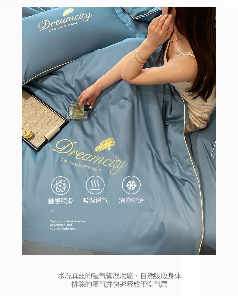 A close-up of a light blue comforter with embroidery, showing a hand touching the fabric.