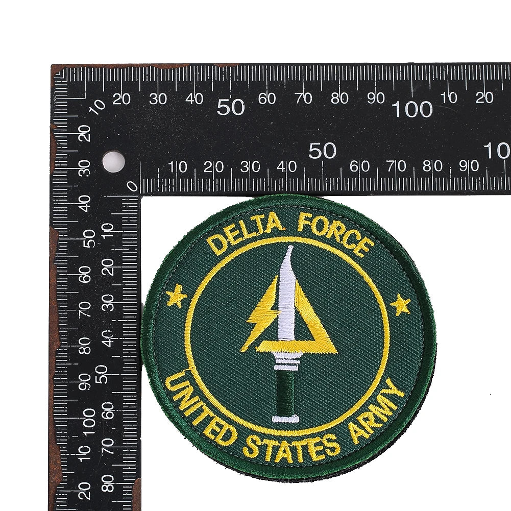 Embroidered patch for the United States Army featuring a delta symbol and text on a dark green background