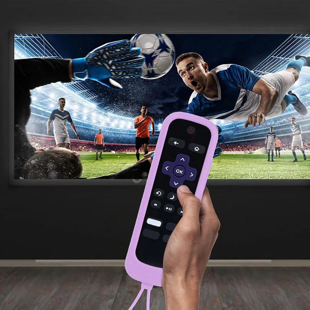 A hand holds a purple glow-in-the-dark silicone remote control cover, positioned in front of a television screen displaying a