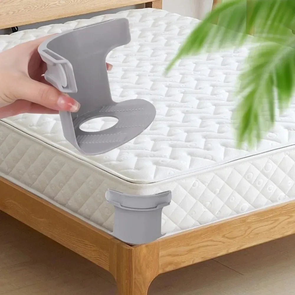 A hand is holding a gray invisible bedsheet corner tightener clip, demonstrating its use for securing mattress or sofa covers