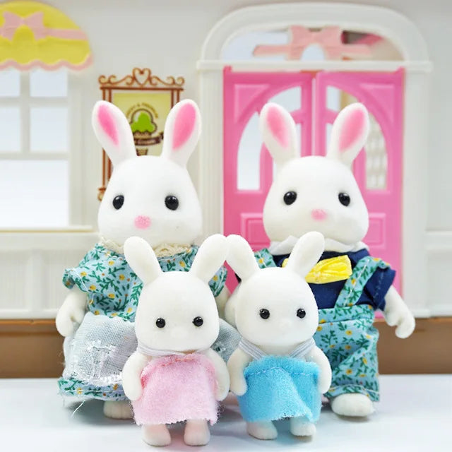 Two white rabbit miniature dolls dressed in floral and blue outfits standing in front of a pink wooden door.