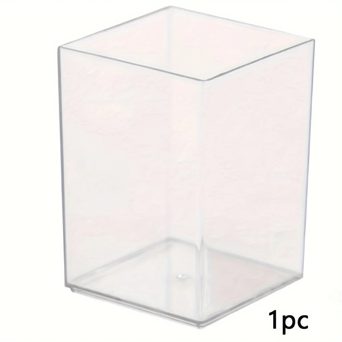 A clear acrylic rectangular pen holder with a slanted bottom.