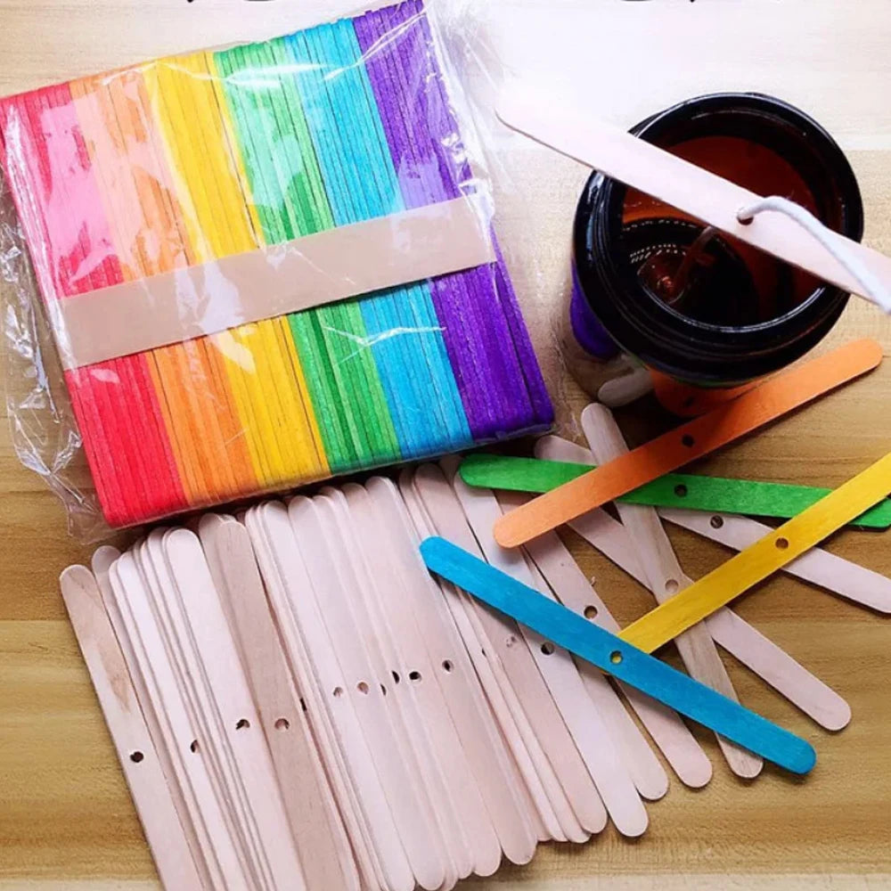 A collection of 53 natural cotton candle wicks with metal stands in various colors and a glass jar.