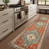 A vintage bohemian trellis runner rug with geometric patterns in orange, blue, and cream sits on a wooden floor.