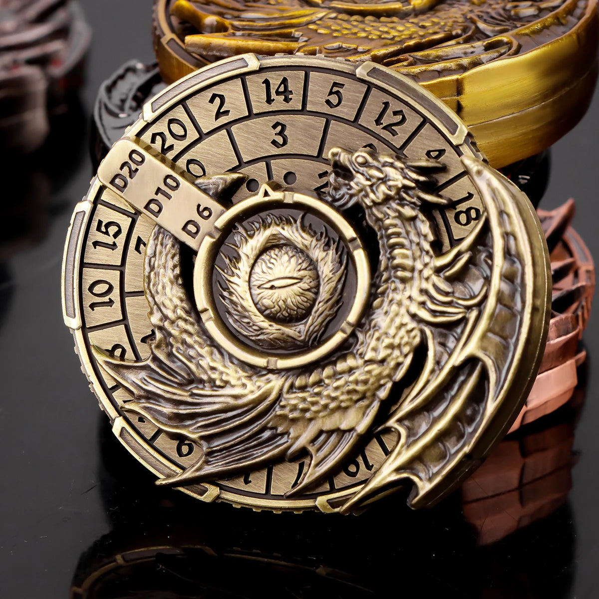 A brass metal spinner dice cube featuring a scale and numbered faces, resting on a dark surface.