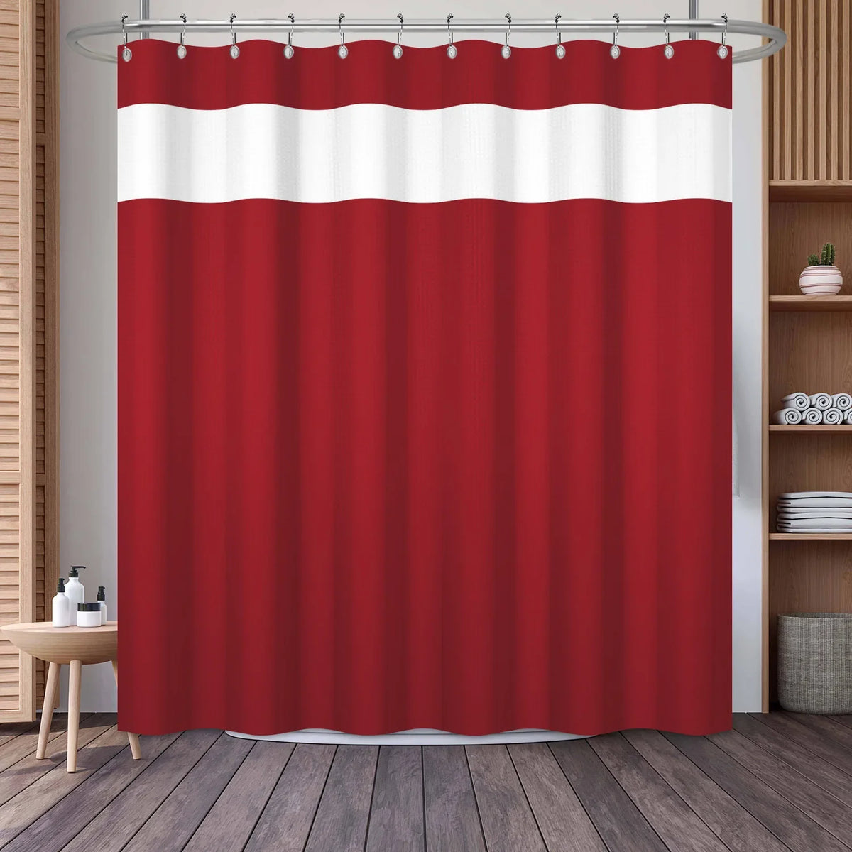 A red shower curtain featuring a geometric stripe pattern hanging on a rod.