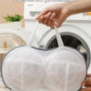 A hand holds a white bra laundry bag with 3D stereo protection against deformation.