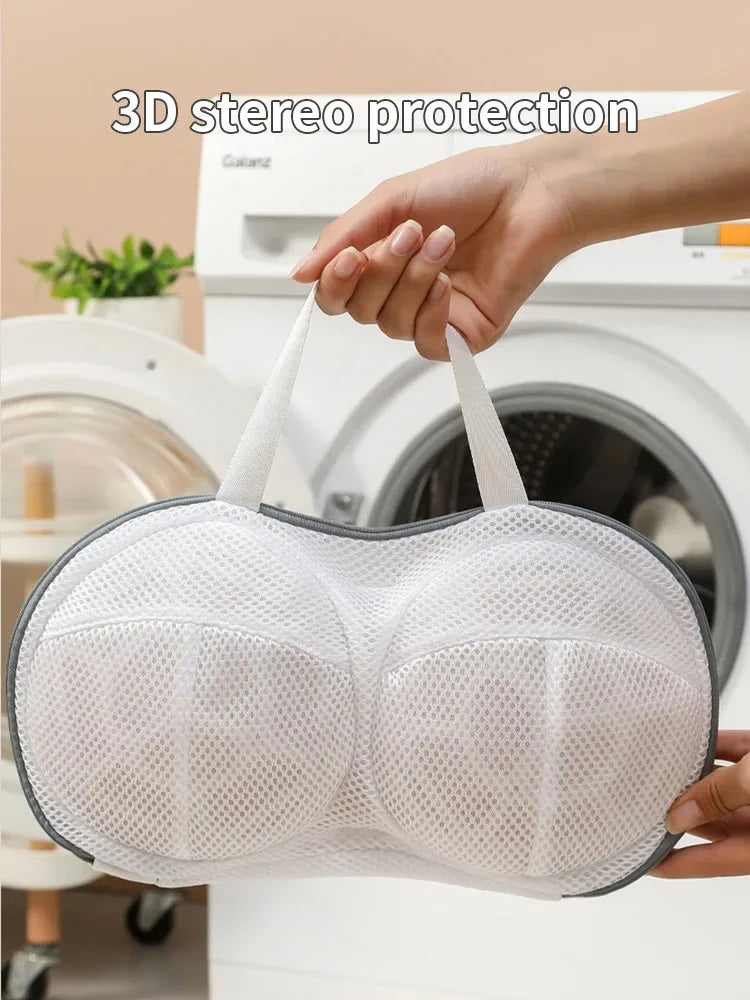 A hand holds a white bra laundry bag with 3D stereo protection against deformation.