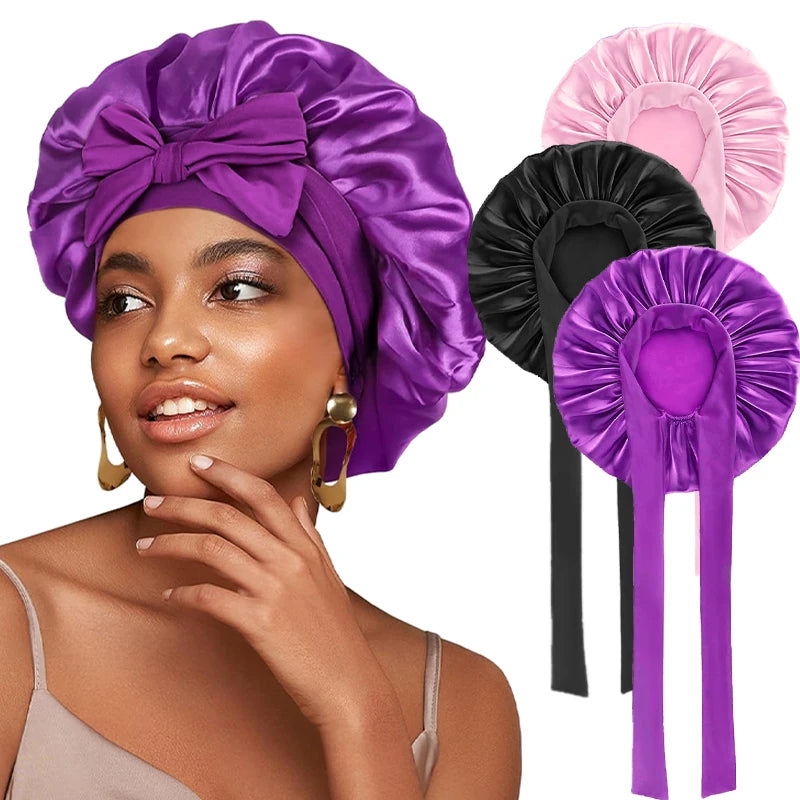 A woman models a purple satin sleeping bonnet and matching headband with adjustable ties.