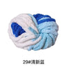 A ball of chunky acrylic yarn featuring blue and white stripes.