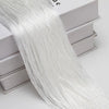 A long, sheer white beaded thread curtain draped over a box.