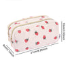 A light pink double-zip pencil case with a repeating red strawberry pattern.