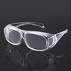 Clear plastic ergonomic reading magnifying glasses with wide lenses shown on a reflective surface.